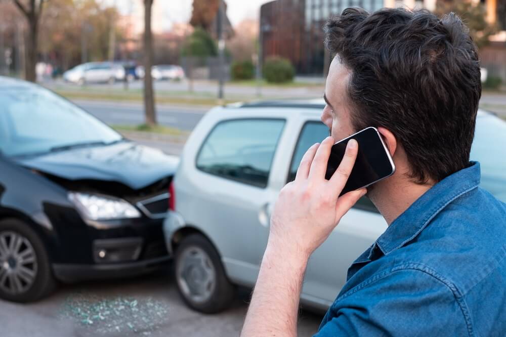 Driver calling police to report accident.