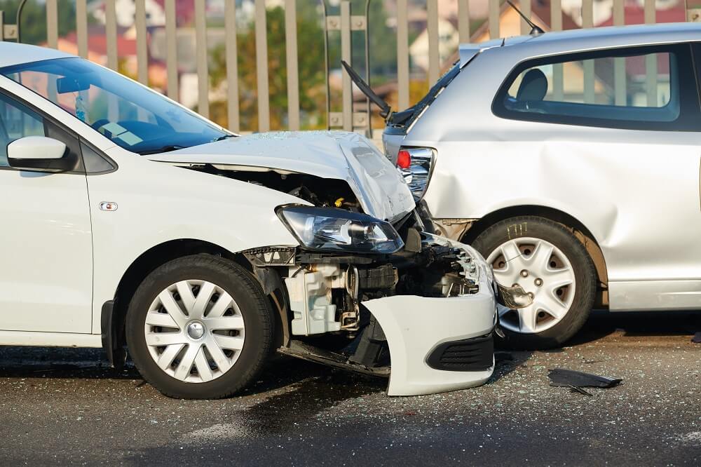 Car collision happening along the highway.