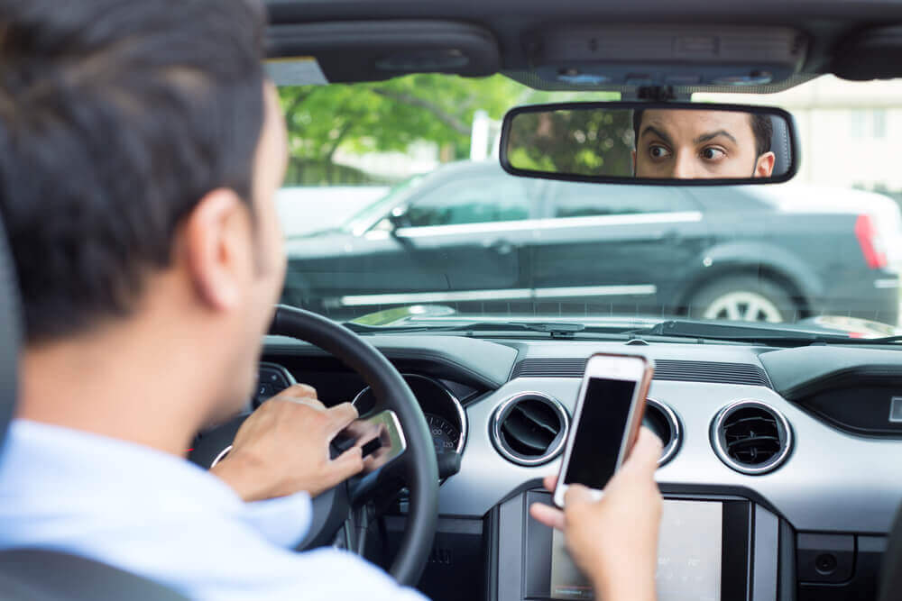 Distracted driver using mobile phone while driving.