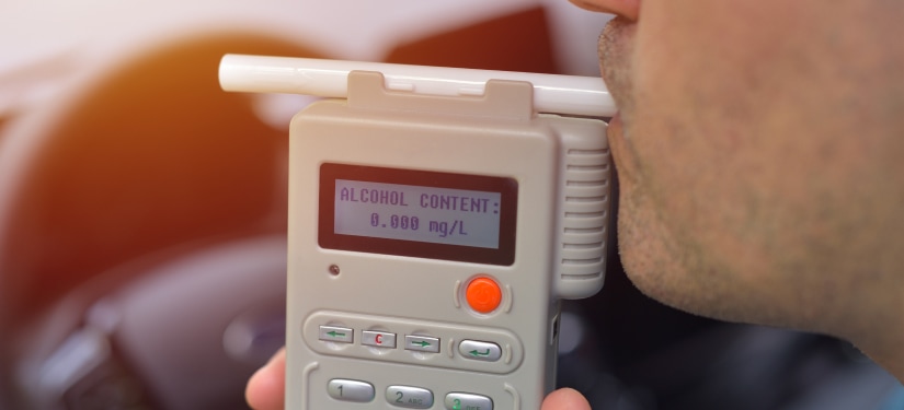 Image of a man being tested using breathalyser
